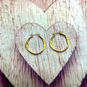 Gold hoop earrings with textured design